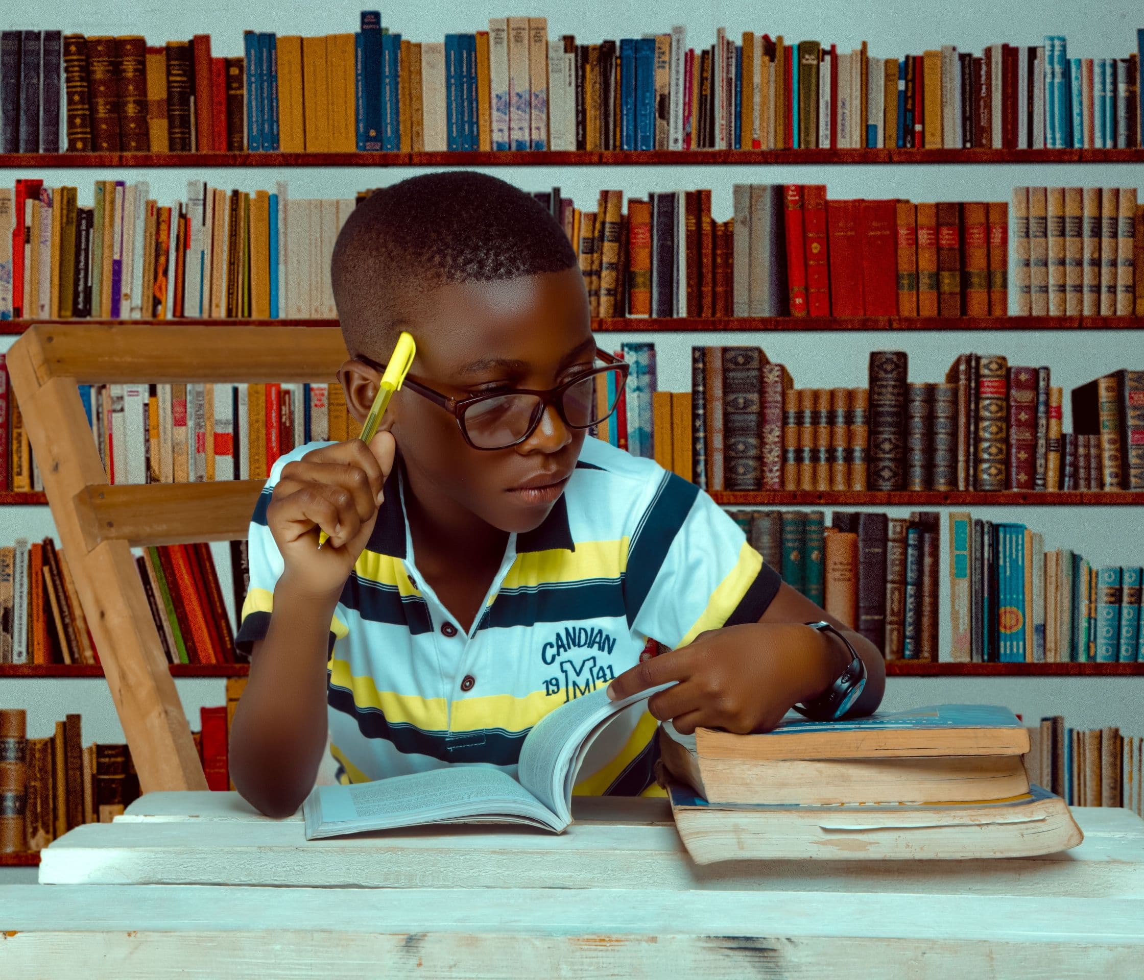 Primary-school pupil studying with books at a desk
